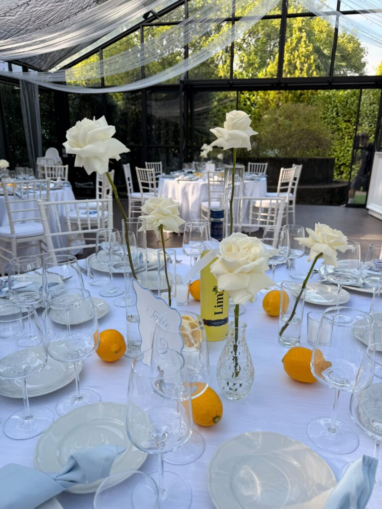 Villa Muggia wedding reception with white roses lemons and glass candle holders